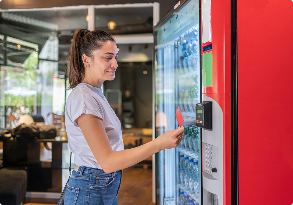 Customer purchasing drink from vending machine