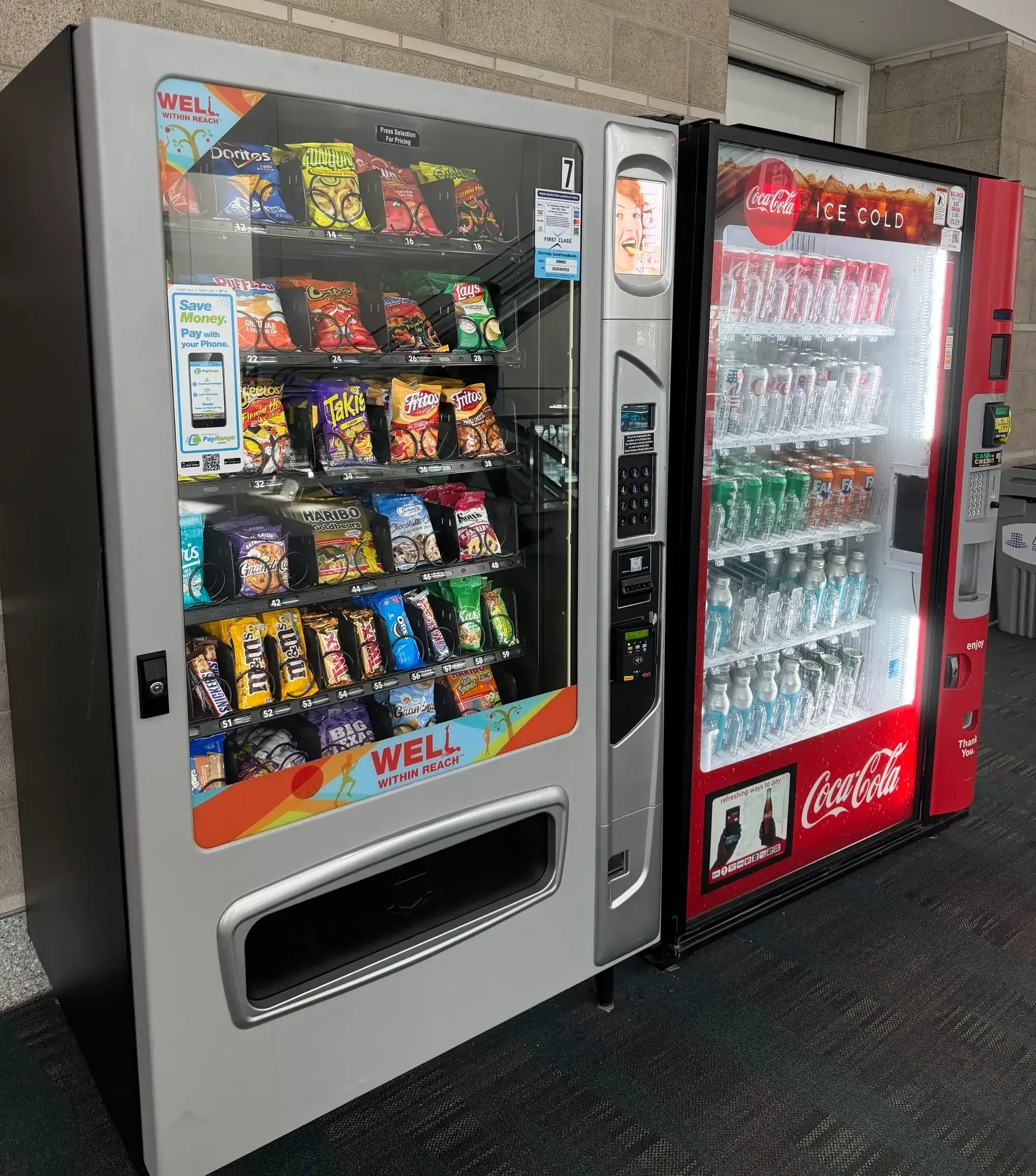 Snack and soda vending machines side by side.